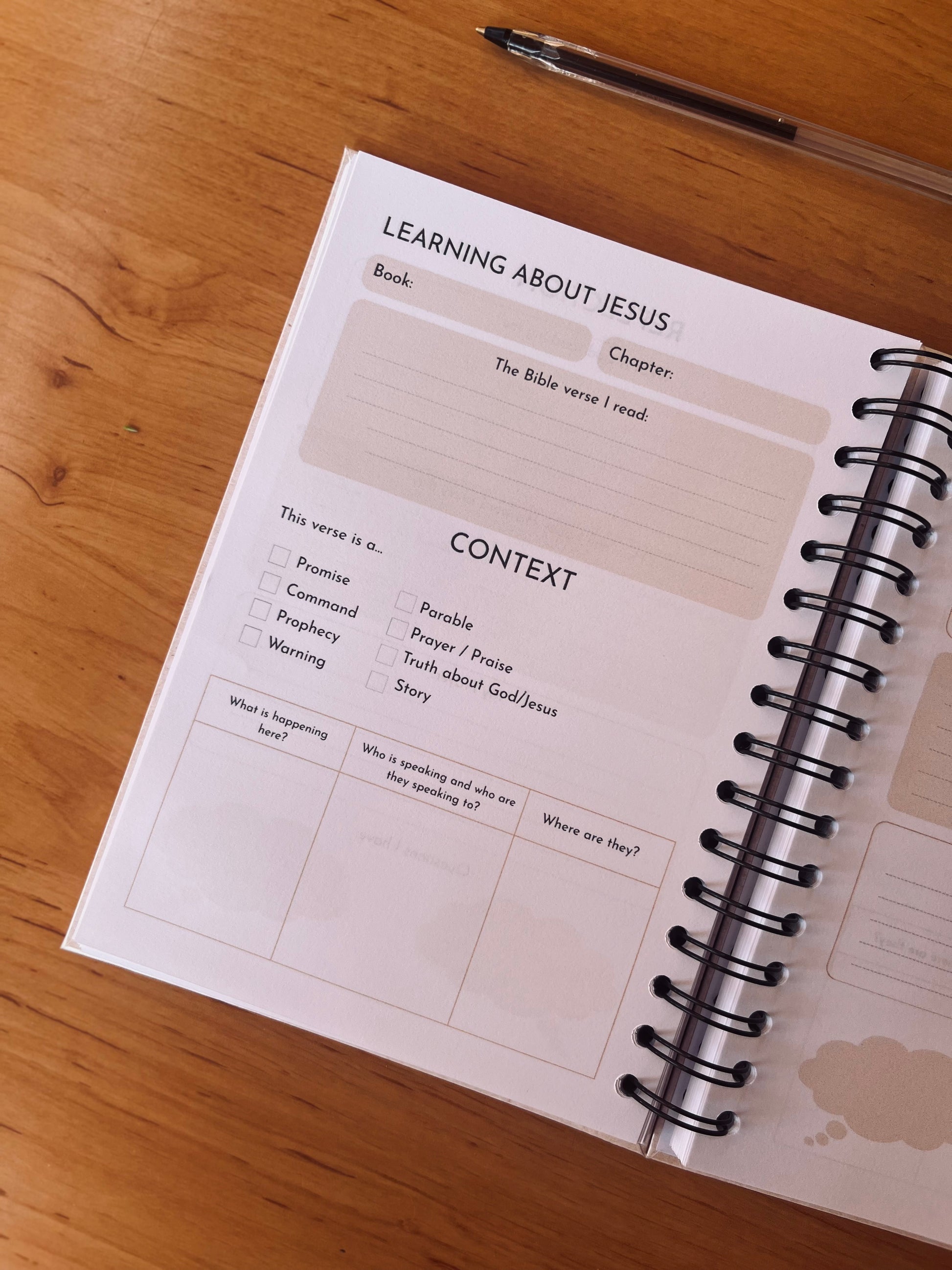 Open Bible Study Journal with a structured layout on a wooden surface